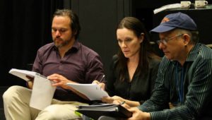 Kirt working as dramaturg with two actors in a play.