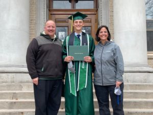 Parents and son in commencement regalia at CSU