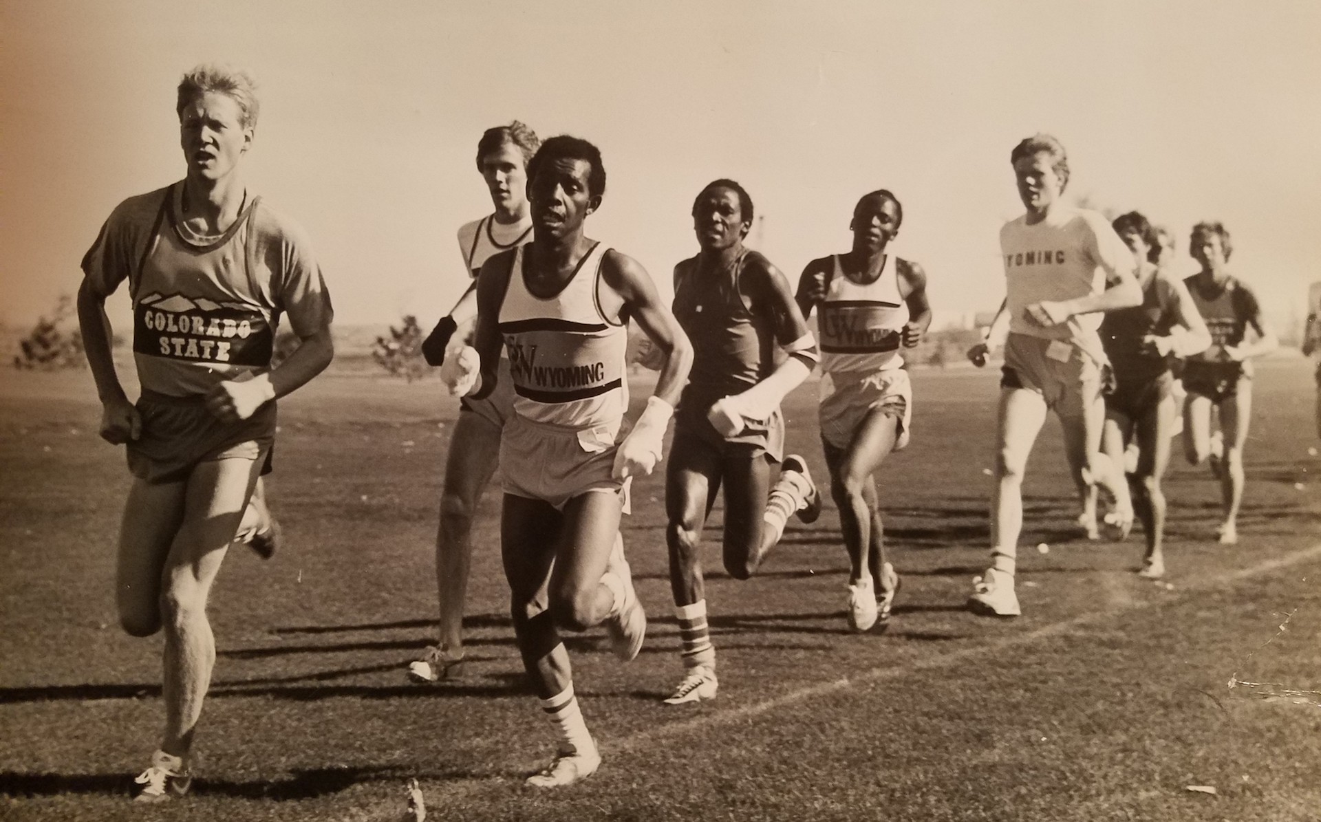 sepia toned image of cross country runners at a meet