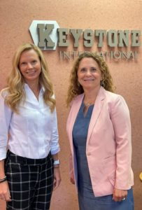 Women posing for a photo in front of Keystone Financial sign