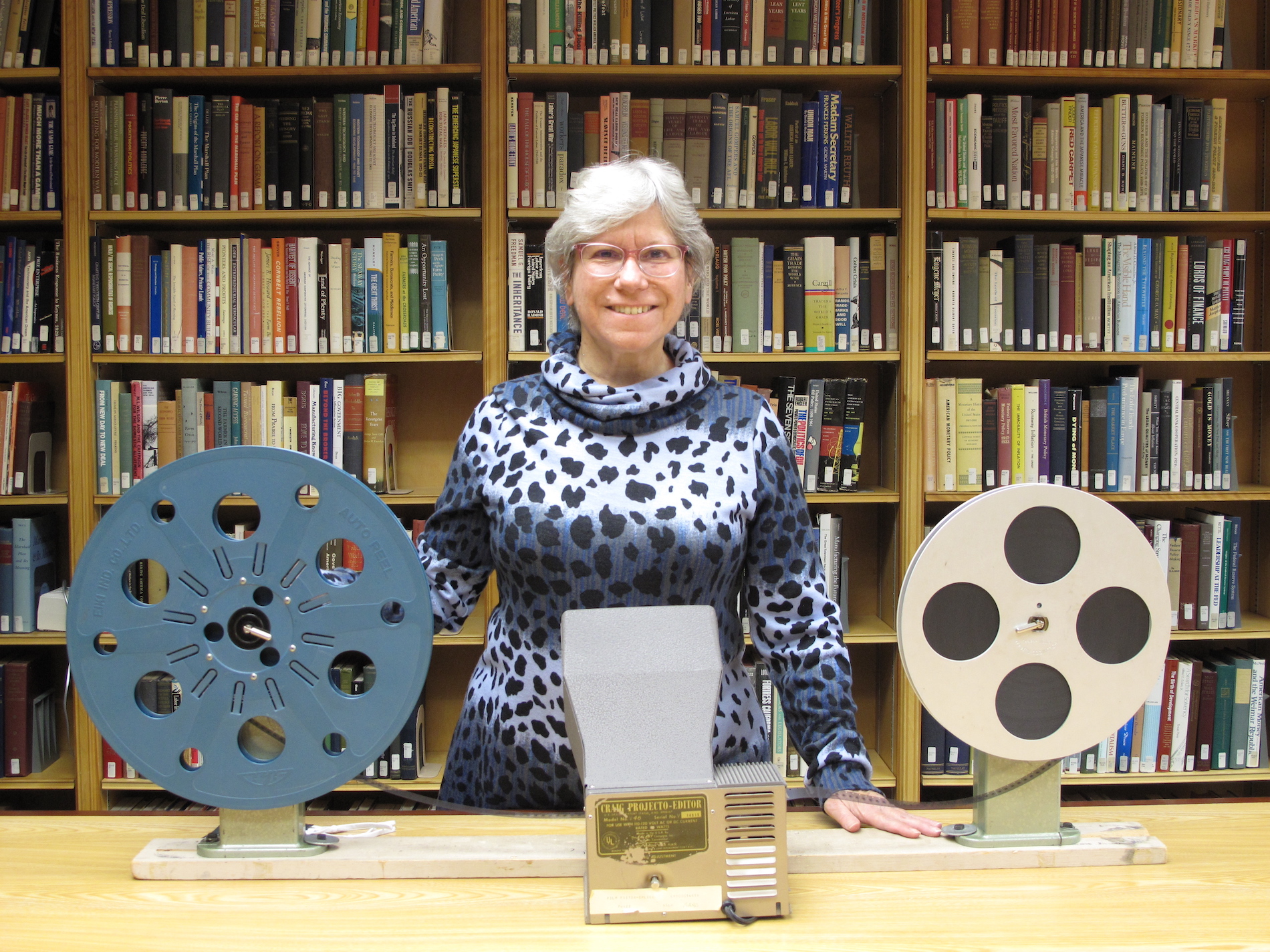 Lynn Smith in library with film reels