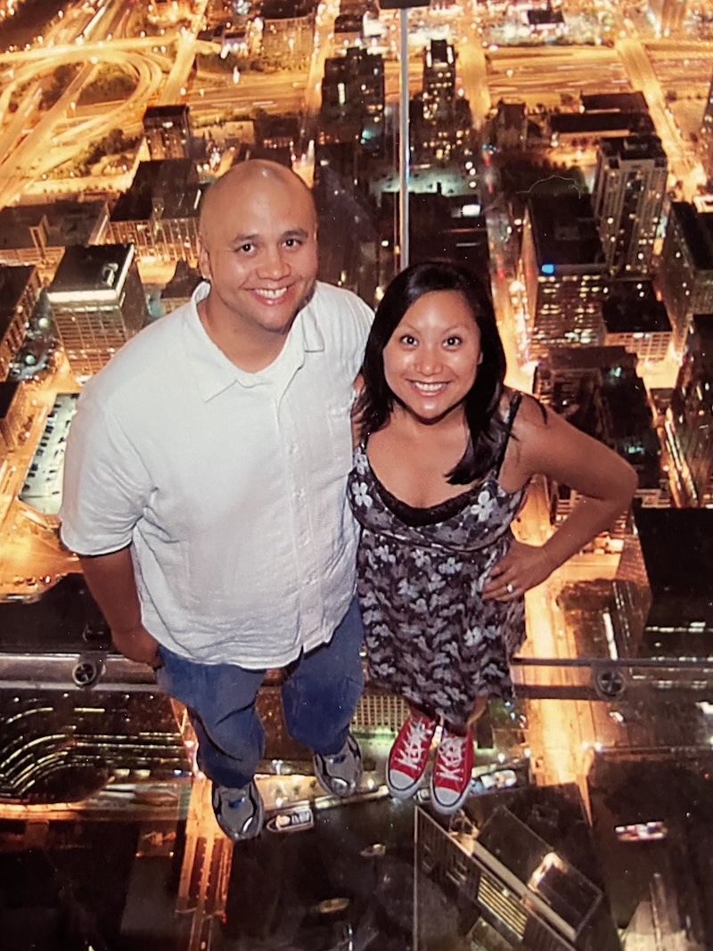 Couple standing on glass platform atop Sears Tower