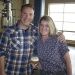 Brendan and Katie McGivney standing in the brewing room of Odell Brewing Co.