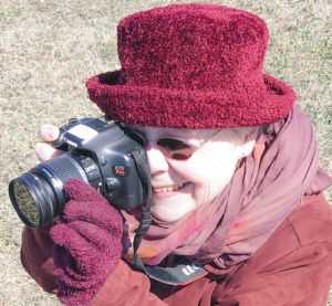 Millicent Eidson takes a picture with a DSLR camera