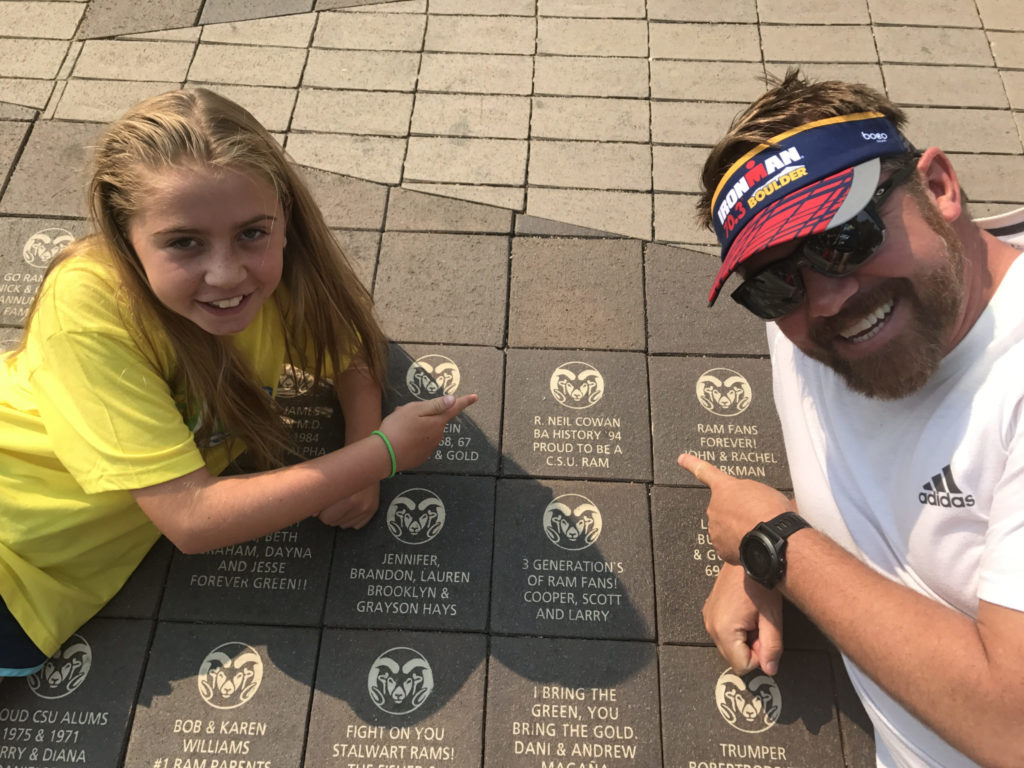 Neil Cowan and his daughter pose in front of their Oval brick