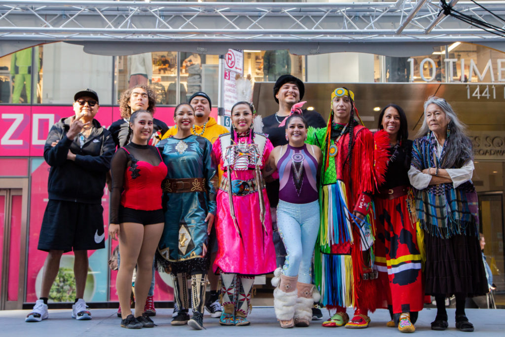 Stephanie Morphet-Tepp and other performers from New York City's first all indigenous variety show pose in Times Square. 