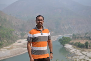 Ajit Karna with a Nepalese river in the background