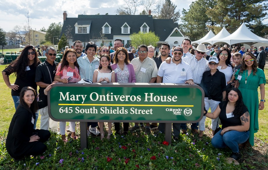 Members of Mary Ontiveros' family gathered around the sign renaming the Diversity House in honor of Mary Ontiveros.