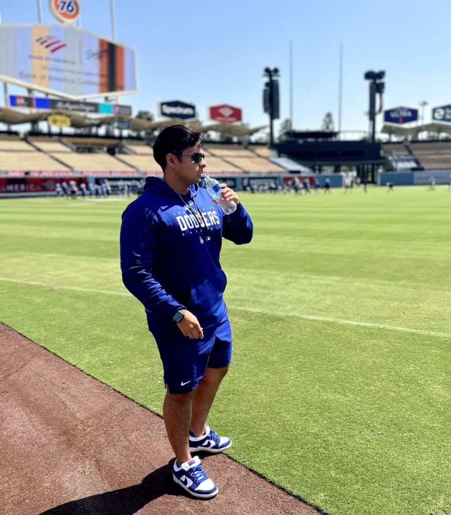 Mario Garcia standing on the sidelines of the LA Dodgers field. 