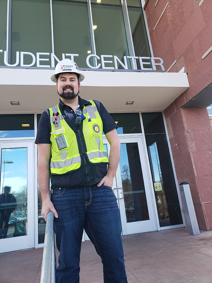 Haselden Construction Manager David Leopold pauses on the steps of the new North Entrance of the Lory Student Center. 