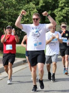 Golditch crossing the finish line at the first Hero's Journey 5K run held on July 23, 2022.