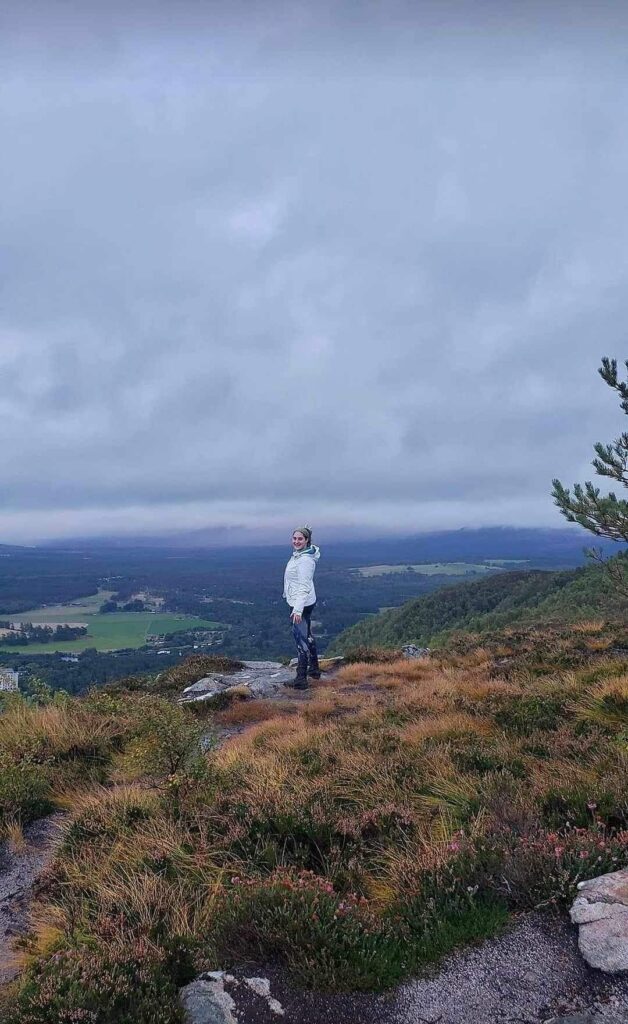 Isabella Wells standing on a cliff in Scotland. 