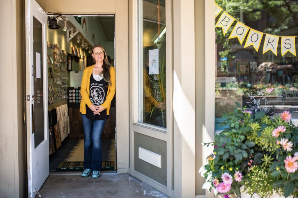 Megan Murray standing in the doorway of her new business, Bookstore On the Square. 