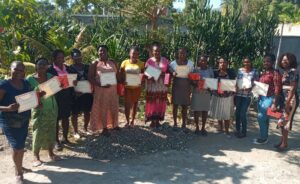 The first class of Loving Haiti's six-month women’s business program with their certificates of completion.