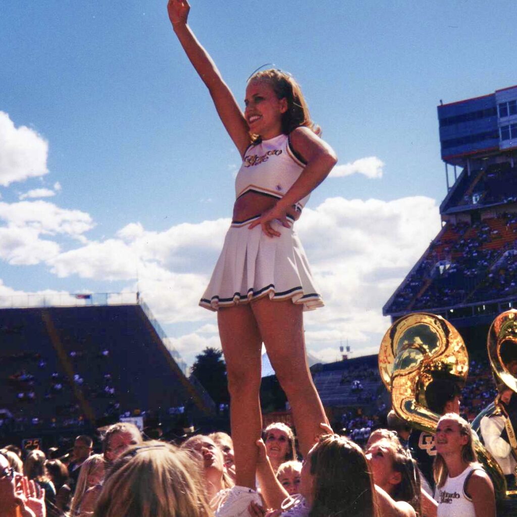 Angela Fuller in a liberty pose as a student cheerleader at CSU. 