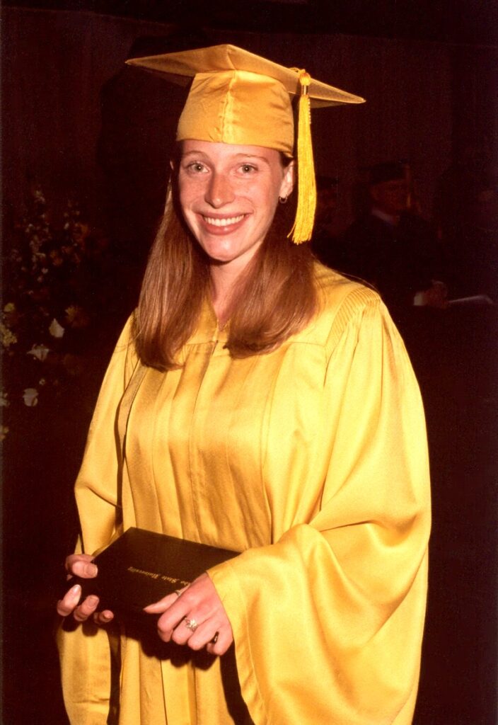 Kerry Knievel in a gold cap and gown for graduation. 